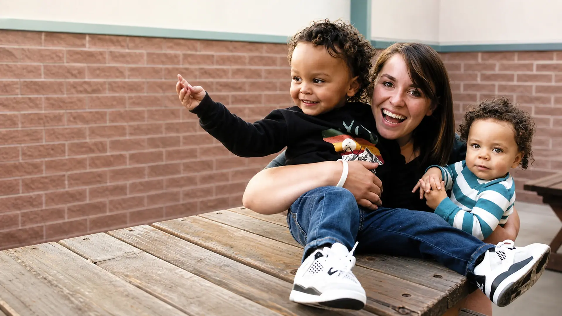 A ChannelMom mother laughing with her two young sons